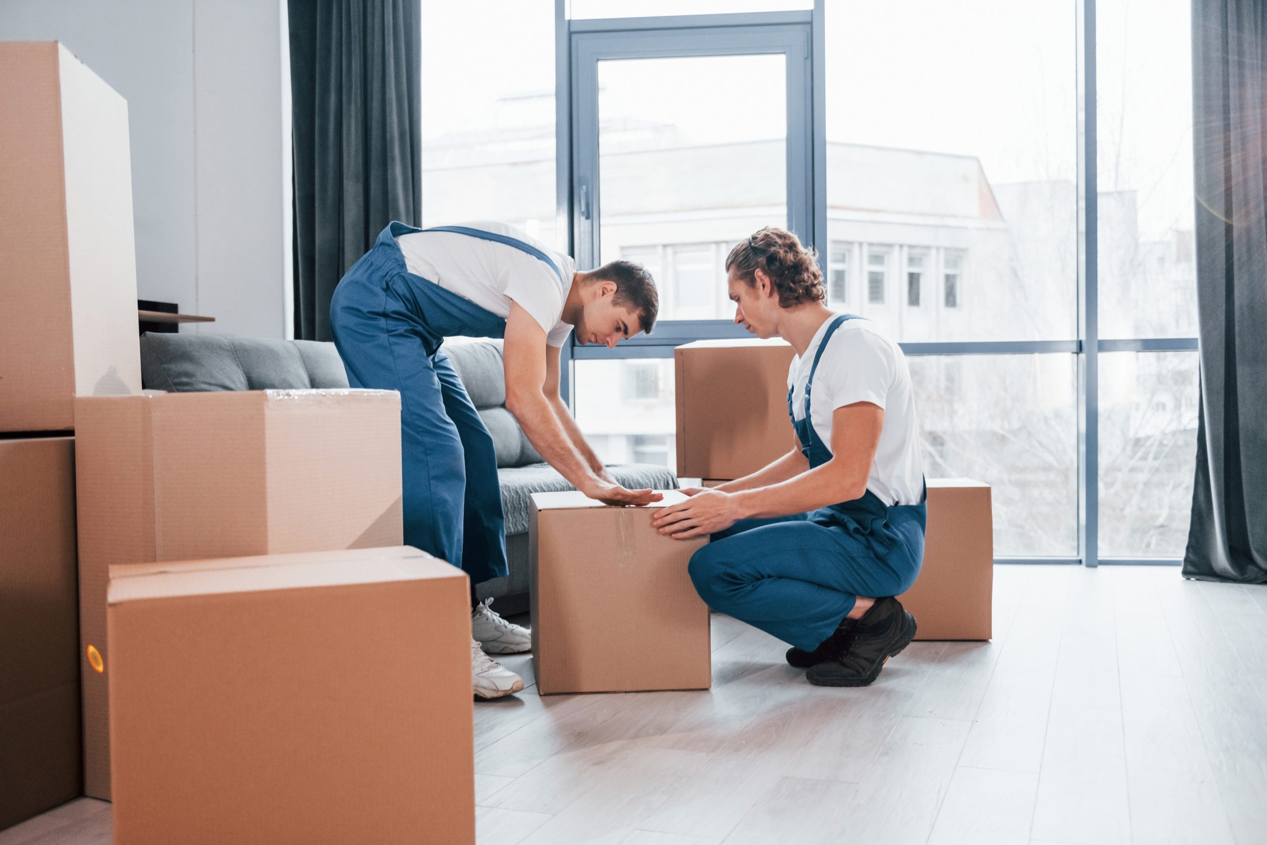 2 men moving boxes
