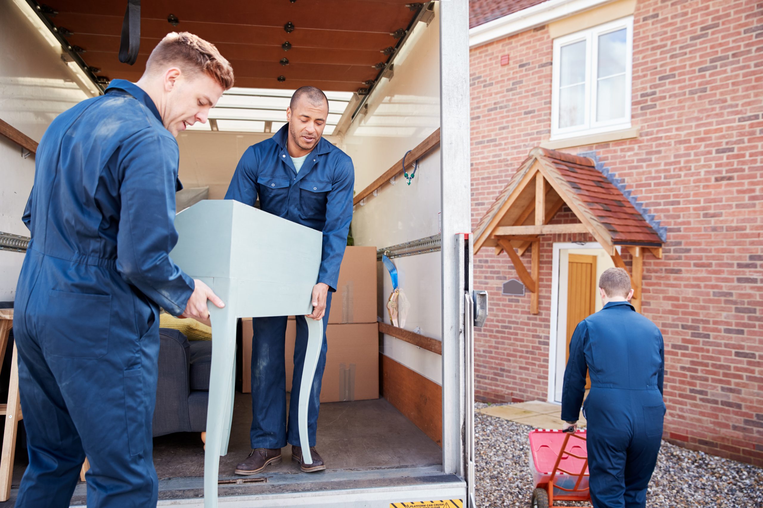 men moving furniture into home