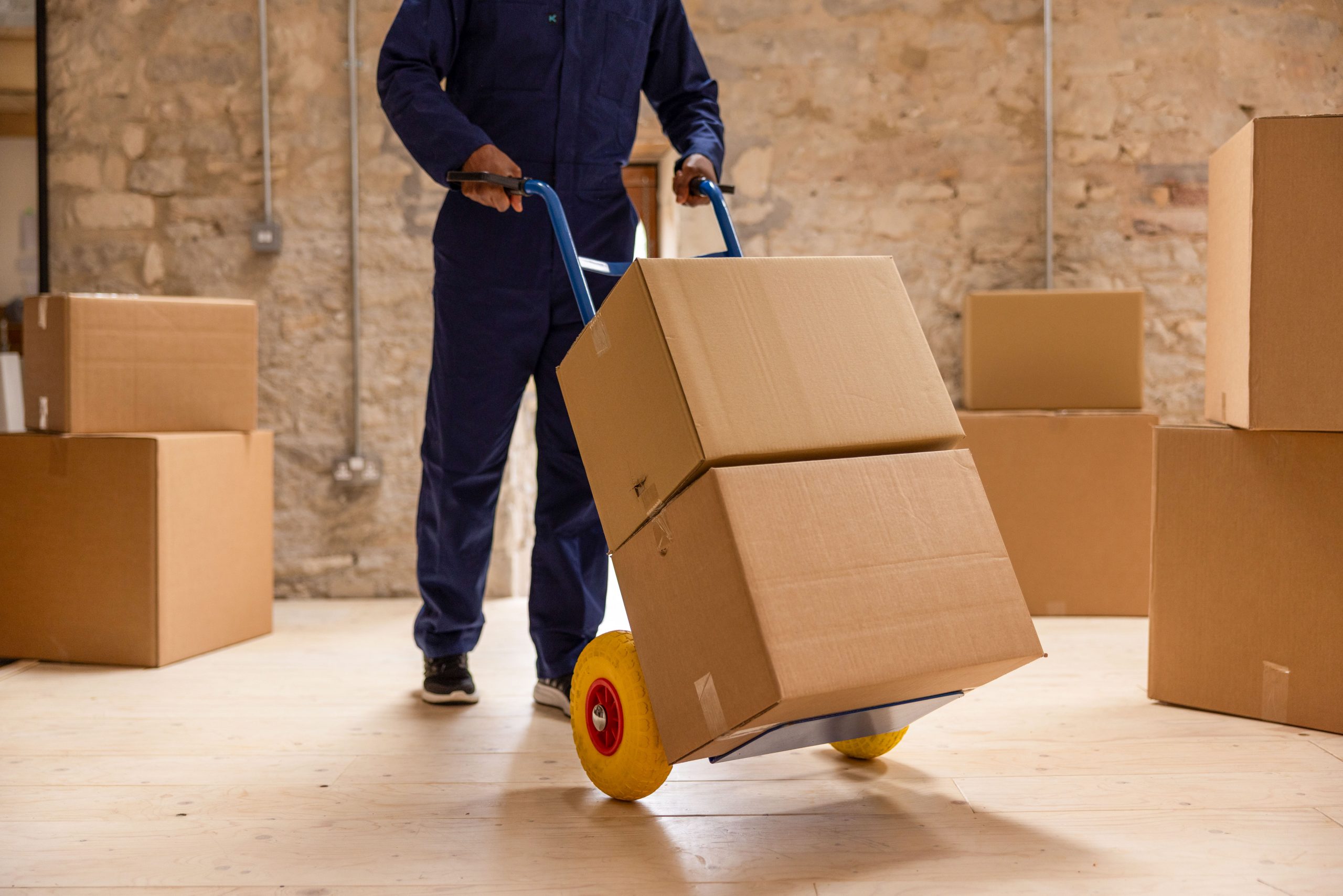 worker moving boxes on a dolly